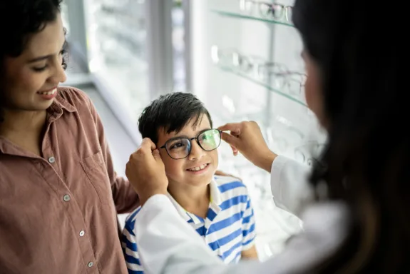 Mother and son buying glasses